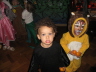 2007 11 04 Ruby dressed as a Crow (missing her beak and eyes) and Bram as a Lion. We unfortunately neglected to get a photo of our whole family outfit. We were Counting Crows. J, Ruby and I were the Crows, and we strung an Abacus between Harper's braced o
