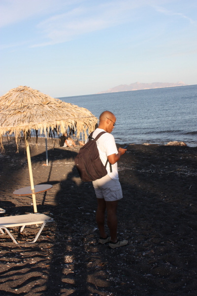 2008 10 08 We finally made it to Santorini!!  But, here's J Working From the Beach